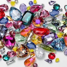 Photo of many colored jewels on a white background